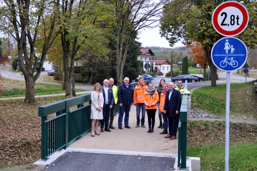 Trägt Radfahrer und Fußgänger sicher über die Sauer – über die neue Brücke freuen sich v.l.: Ute Dülfer (Bürgermeisterin Stadt Lichtenau), Hans-Bernd Janzen (stellv. Landrat), Wolfgang Scholle (Kreistagsabgeordneter), Josef Meiwes (Ortsvorsteher Atteln), Thorsten Kammel (Büro Bockermann + Fritze), Mona Reffert (Büro Bockermann + Fritze), Janina Uhle (Kreisstraßenbauamt), Frank Behre (Bauunternehmen Nolte), Christoph Rüther (Landrat) und Jens Kaiser (Kreisstraßenbauamt)  Foto: Kreis Paderborn, Kreisstraßenbauamt, Michael Rüngeler